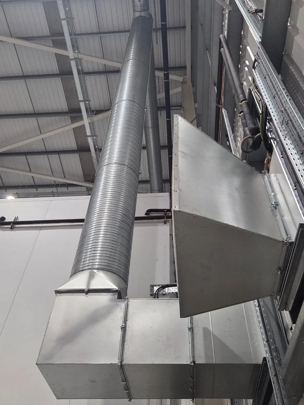 Vertical induction ducting rising inside the warehouse