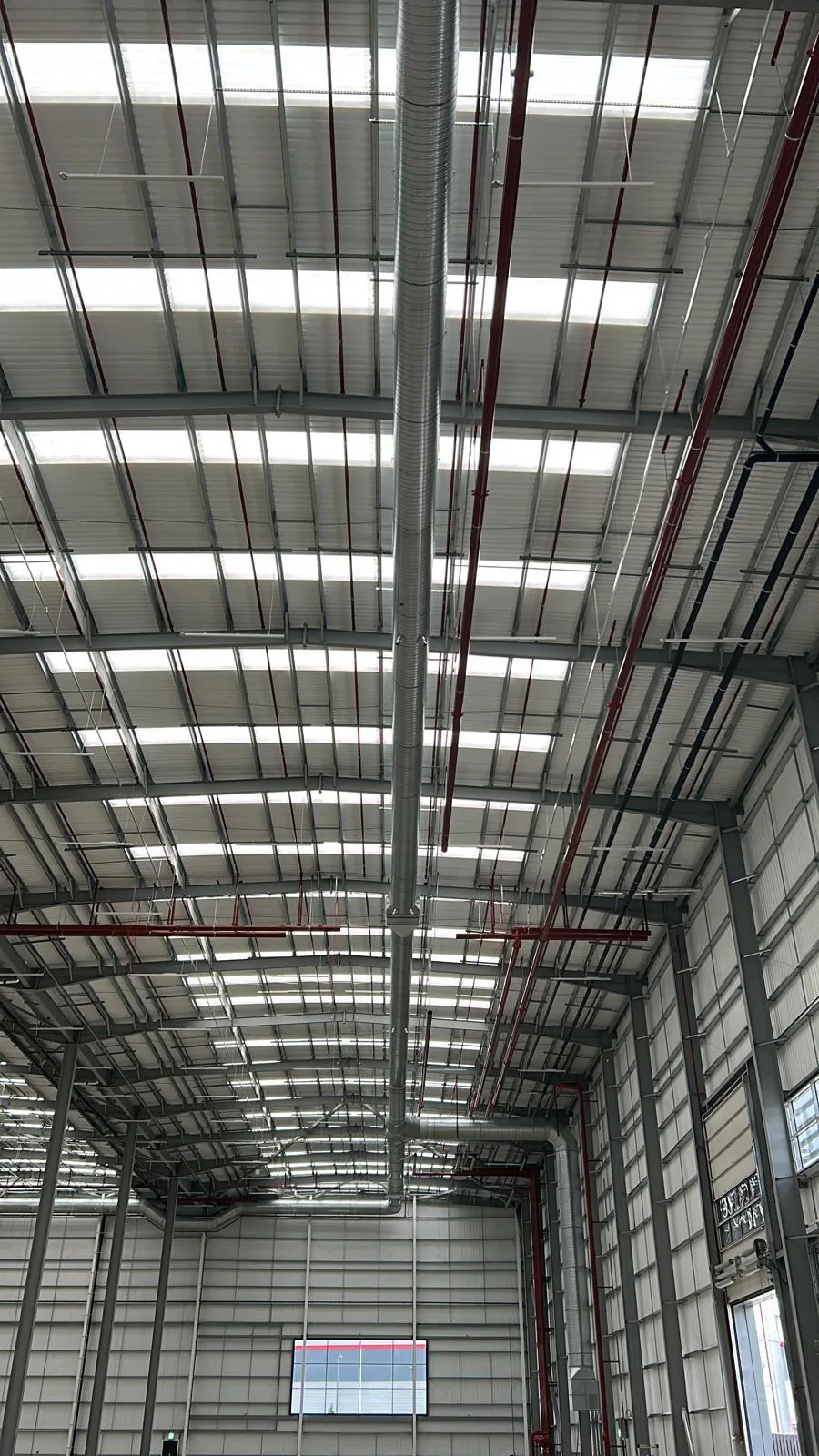 Spiral ductwork riser distributing conditioned air inside the DC9 warehouse