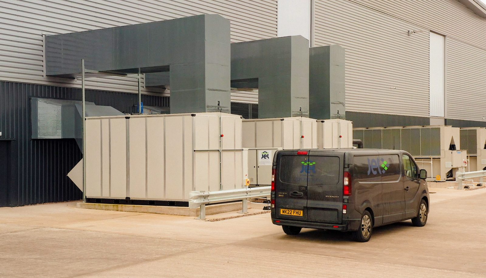 A Jet Environmental service van beside air handling units outside a large industrial building