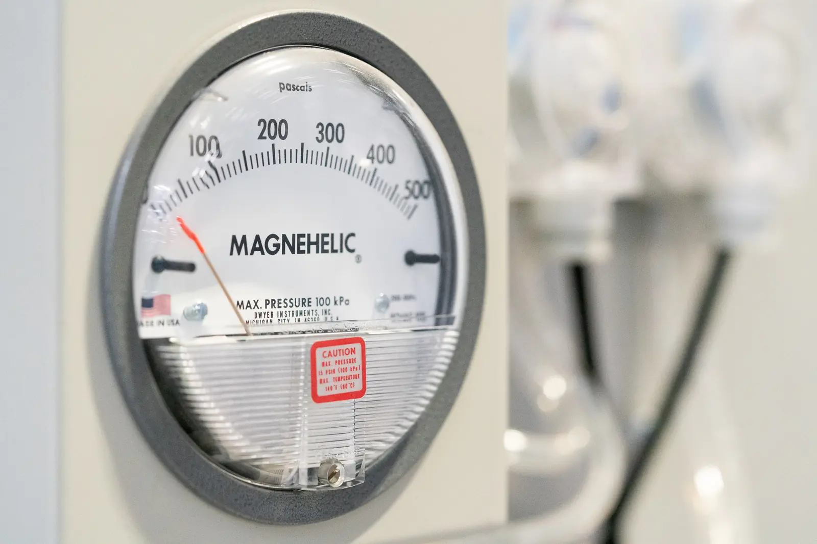 Close-up of a differential pressure gauge calibrated in pascals
